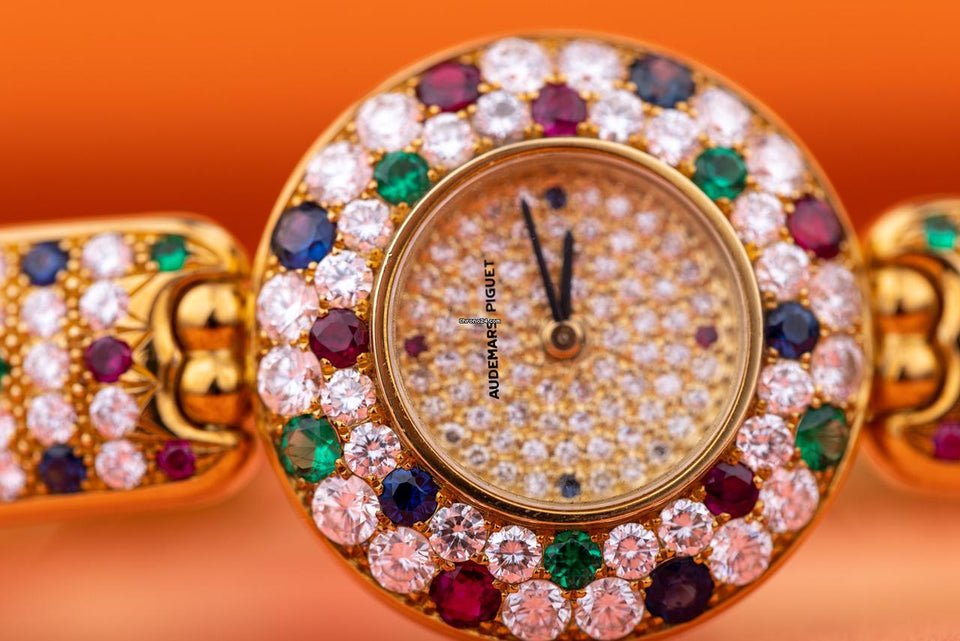 Audemars Piguet Unworn Extremely Rare Lady Wristwatch | Unique Pave Diamonds Emeralds Sapphires and Rubies | 18k Yellow Gold