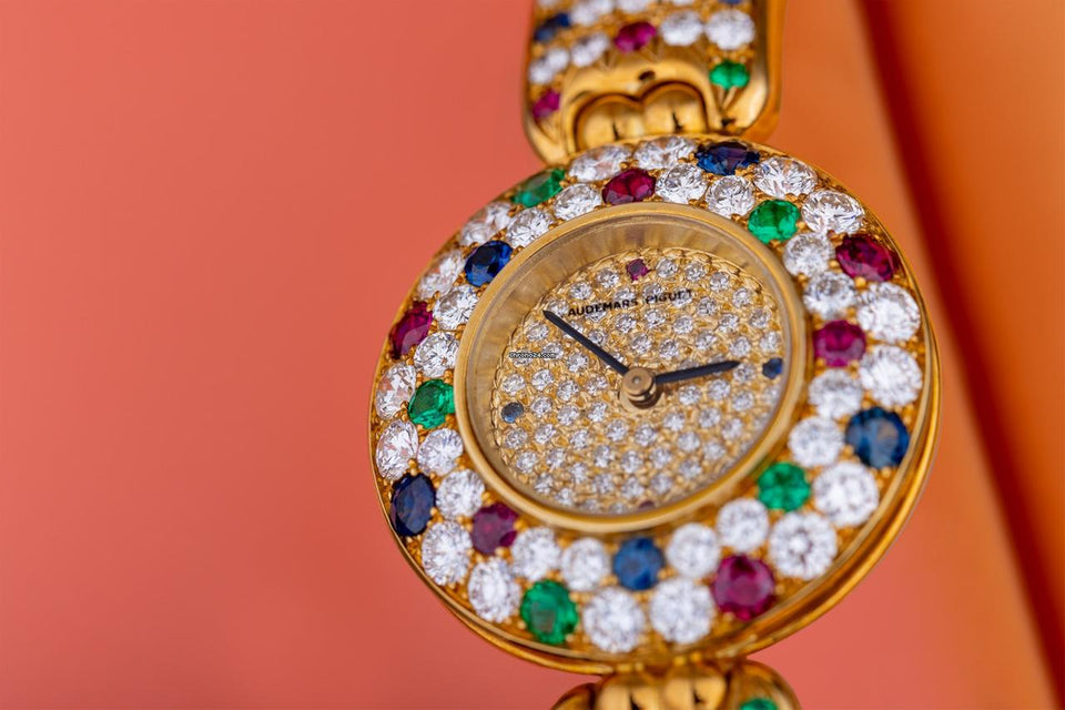 Audemars Piguet Unworn Extremely Rare Lady Wristwatch | Unique Pave Diamonds Emeralds Sapphires and Rubies | 18k Yellow Gold